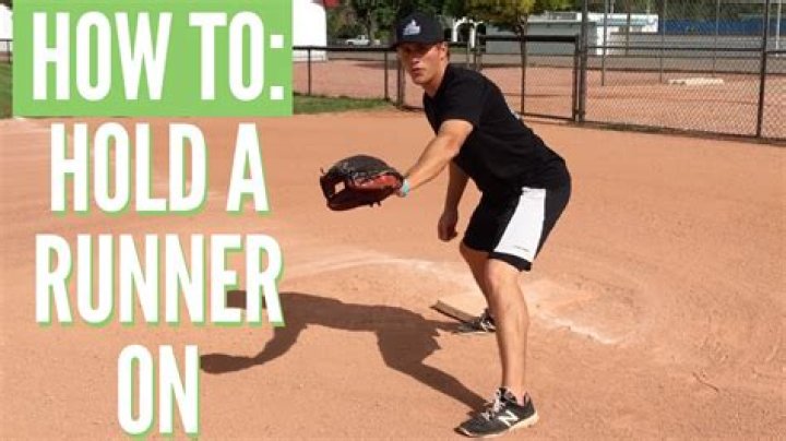 How should a left-handed first baseman hold a runner on first?