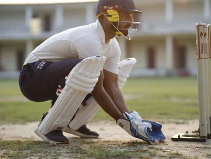 What equipment does a wicket-keeper wear?