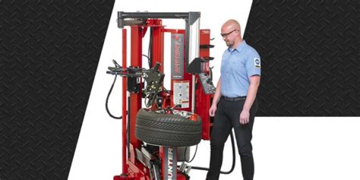 What PPE must be worn while using a tire changing machine?