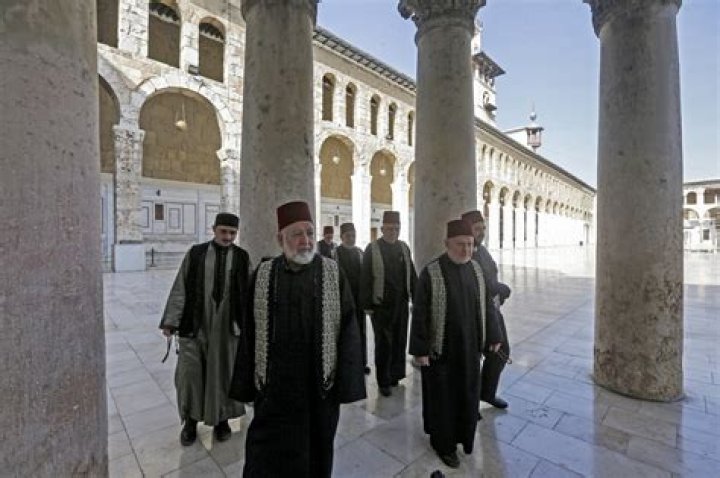 Who does the Adhan in Mecca?